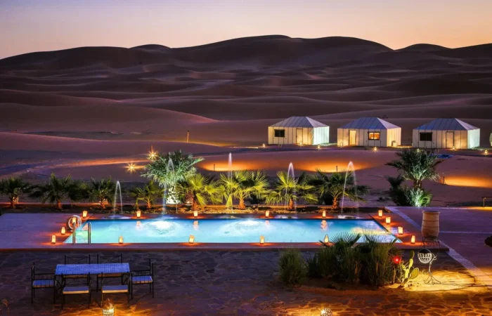 3-day desert tour from Fes to Marrakech with camel trekking in Merzouga dunes, Sahara sunset, Berber camp experience, and Atlas Mountains landscapes