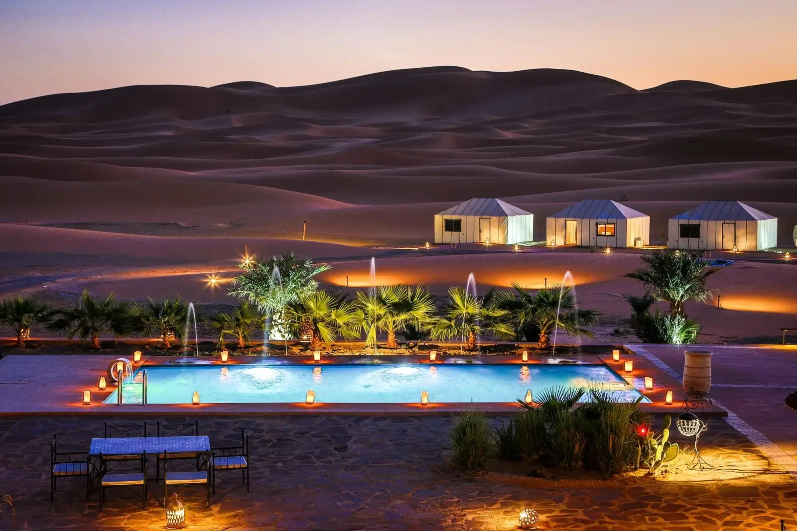 3-day desert tour from Fes to Marrakech with camel trekking in Merzouga dunes, Sahara sunset, Berber camp experience, and Atlas Mountains landscapes